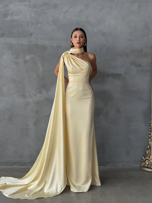 فستان سهرة أصفر بكتف واحد مزين بشال وتفاصيل غير متماثلة من الساتان